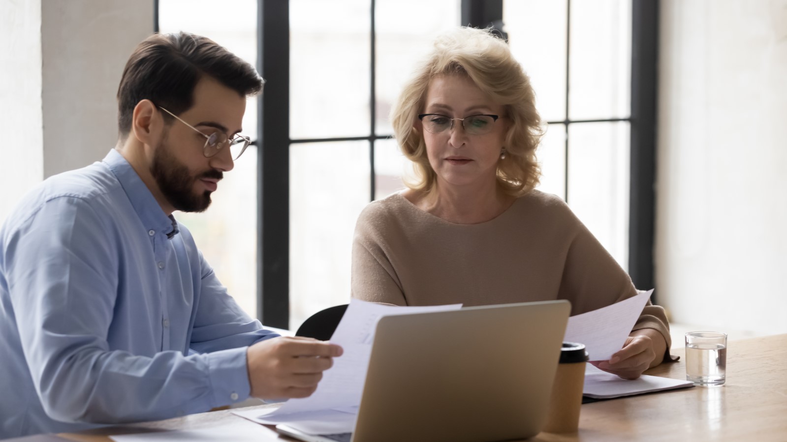 Diverse businessman and mature businesswoman